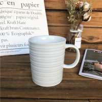 Promotional white 440ml ceramic mug with embossed for daily use